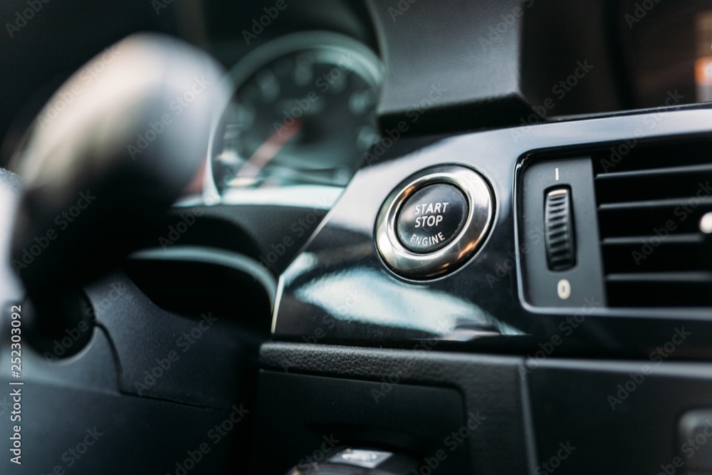 finger pressing the start button, stop the engine in the car. The driver is ready for the trip. finger pressing the start button, stop the engine in the car. The driver is ready for the trip.