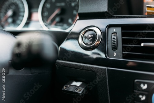 finger pressing the start button, stop the engine in the car. The driver is ready for the trip. © velimir