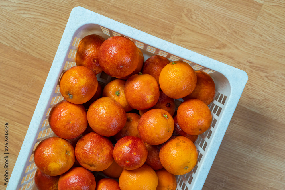 fresh red oranges in plastic crate top view b