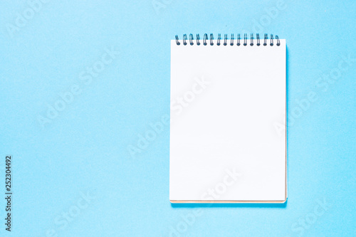 Notebook on blue top view.