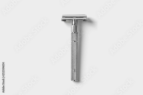 Vintage safety metal razor isolated on a soft gray background.High resolution photo.