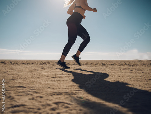 Fototapeta Naklejka Na Ścianę i Meble -  blondie woman wearing sport cloth running on the beach