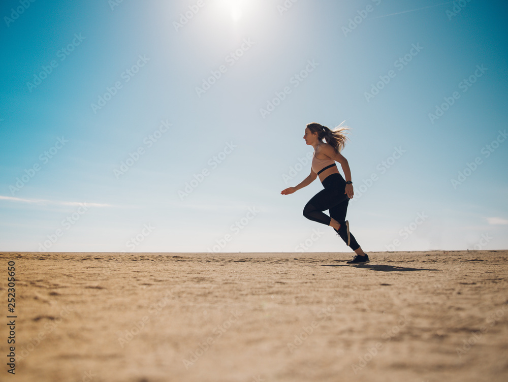 blondie woman wearing sport cloth running on the beach blondie woman wearing sport cloth running on the beach