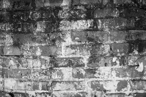 Texture of black and white brick with scratches and cracks