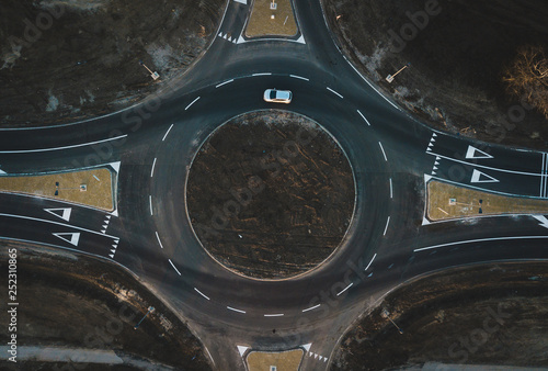 Fototapeta Naklejka Na Ścianę i Meble -  aerial view of cars are moving through a newly built traffic circle