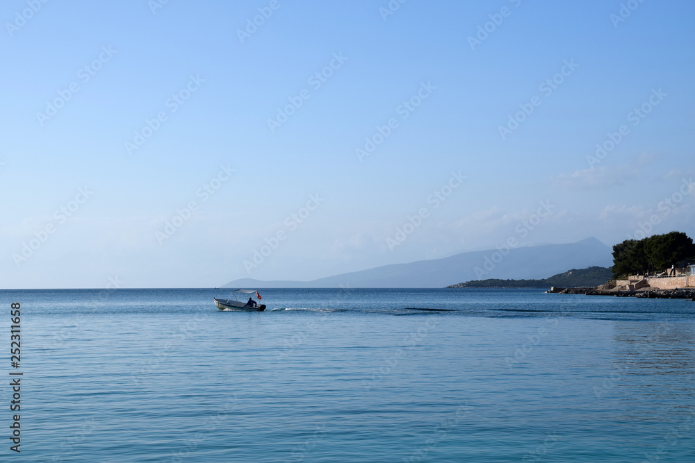 Small boat floats in the sea. Albanian riviera, Ksamil near Saranda. Albania.