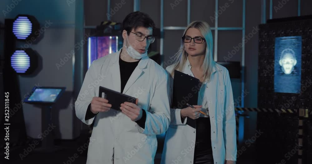 Young scientists go to the scientific laboratory and discuss work plans. Space laboratory is equipped with screens and lighting lamps. Young scientists go to the scientific laboratory and discuss work plans. Space laboratory is equipped with screens and lighting lamps.