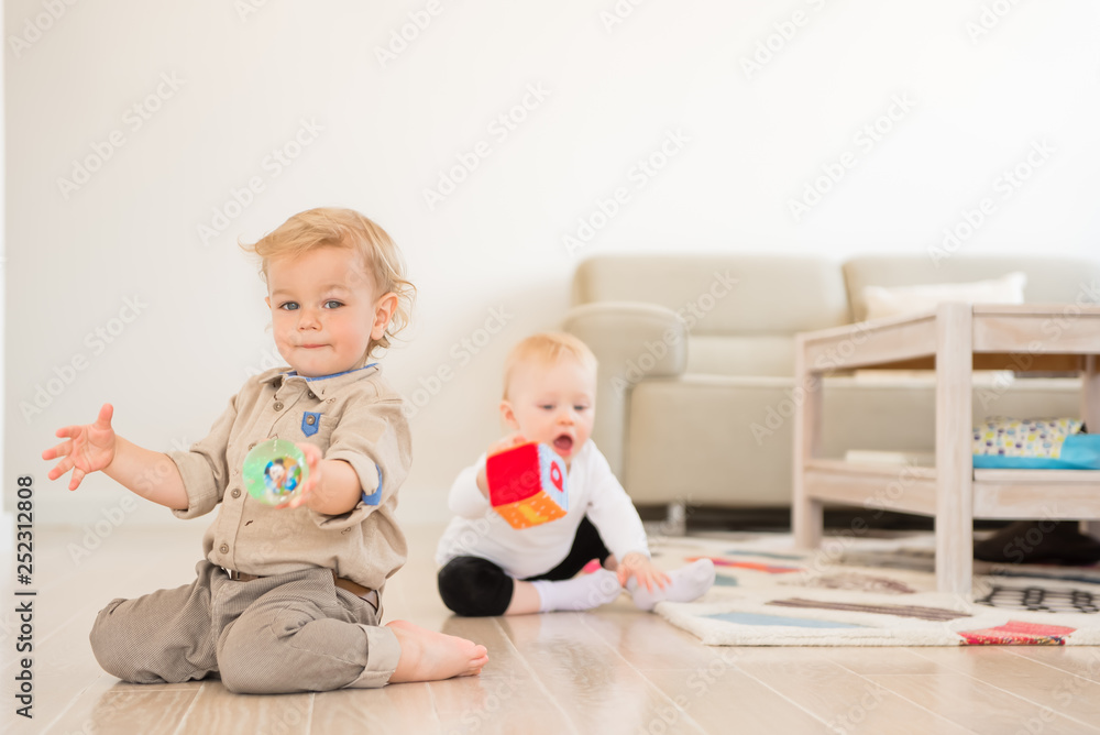 Cute little girl and boy playing with toys at home Cute little girl and boy playing with toys at home