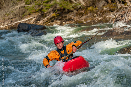 Man whitewater kayaks