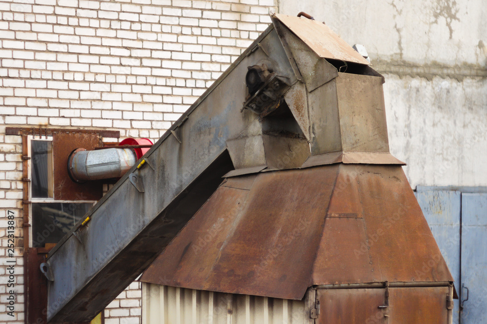 Rusty industrial construction against a backdrop of brick wall