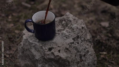 Blue cup of coffee on the stone.