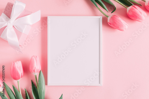 Flowers composition romantic. Flowers pink tulips, photo frame on pastel pink background. Wedding. Birthday. Happy woman's day. Mothers Day. Valentine's Day. Flat lay, top view, copy space © prime1001
