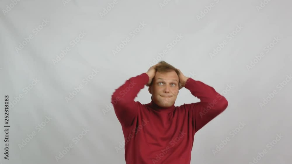 Young handsome man in red sweater posing for the camera Young handsome man in red sweater posing for the camera