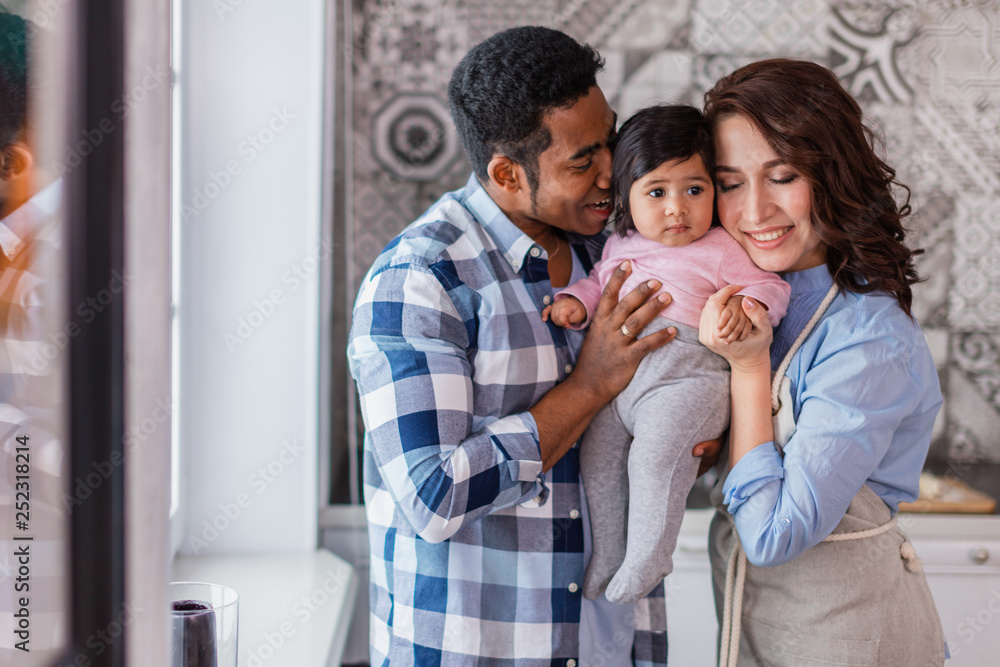 young happy parents enjoying time with their baby, close up photo.warm relationship among family members young happy parents enjoying time with their baby, close up photo.warm relationship among family members