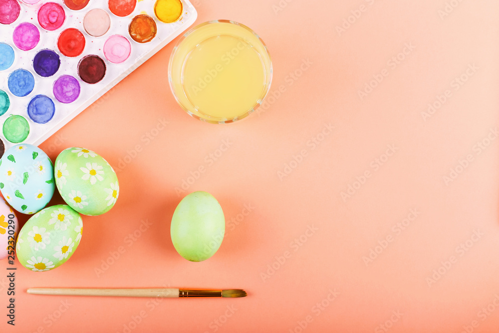 Hand painted Easter eggs, paints and brushes on a table. Preparation for the holiday. Hand painted Easter eggs, paints and brushes on a table. Preparation for the holiday.