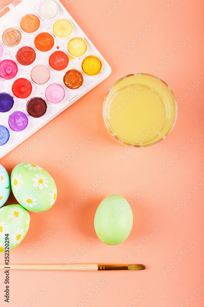 Hand painted Easter eggs, paints and brushes on a table. Preparation for the holiday. Hand painted Easter eggs, paints and brushes on a table. Preparation for the holiday.