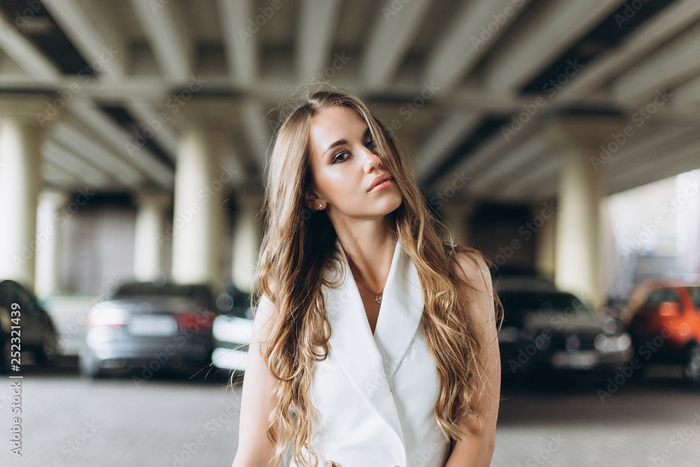 Fototapeta premium Young sexy slim young woman posing outdoors with new sport car outdoors. Fashion, transport, luxury concept 