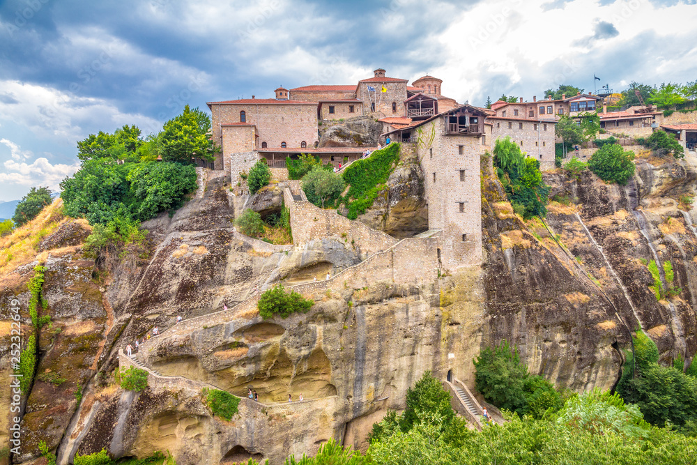 The Meteora with dramatic overcast sky, a rock formation hosting built complexes of monasteries,  Greece, Europe.