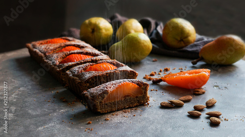 Pear cake and fruits on table