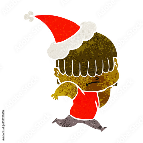 retro cartoon of a boy with untidy hair wearing santa hat