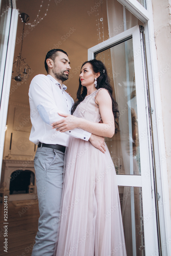 Tender beautiful romantic happy wedding couple hugging each other and holding hands. Bride and groom together in love. Happiness, family, couple concept Tender beautiful romantic happy wedding couple hugging each other and holding hands. Bride and groom together in love. Happiness, family, couple concept