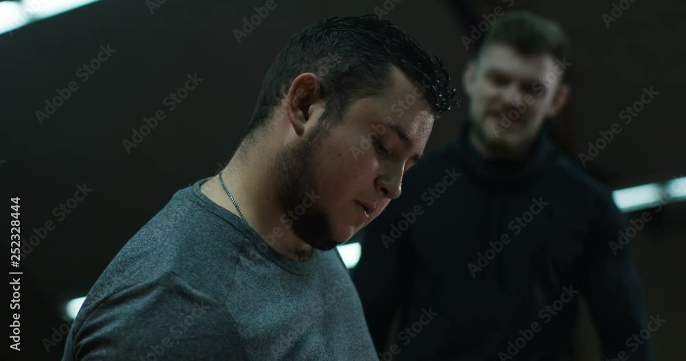 Trainer yelling at weightlifting young man Trainer yelling at weightlifting young man