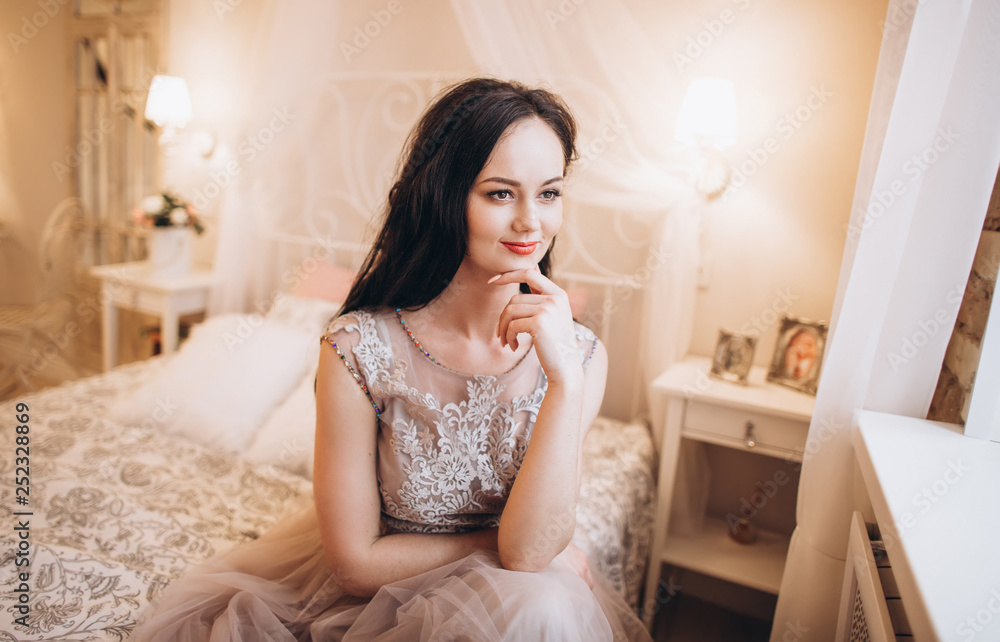 Tender elegant bride in wedding dress. Fashion beauty brunette girl preparing for a marriage Tender elegant bride in wedding dress. Fashion beauty brunette girl preparing for a marriage