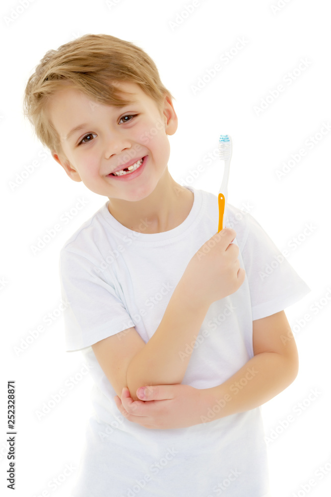 A little boy is brushing his teeth with a toothbrush.
