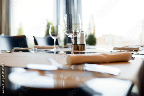 cutlery and wine glasses on a black table © ruslanseradziuk