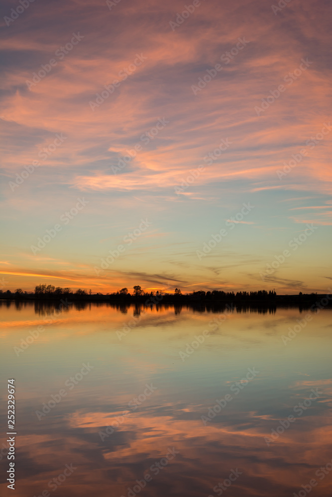 Beauty clouds after sunset reflecting in a calm lake