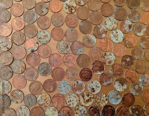 A pile of tarnished and partially corroded British copper coins - one pence pieces (1p) - and a lot of corrosion and verdigris