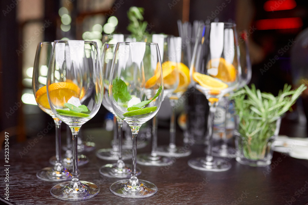 wine glasses filled with lemon, lime and mint on a brown table wine glasses filled with lemon, lime and mint on a brown table