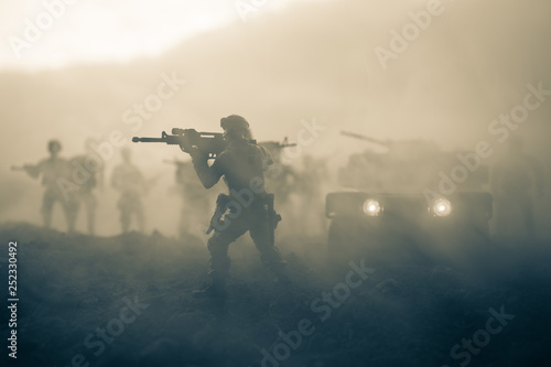 Military patrol car on sunset background. Army war concept. Silhouette of armored vehicle with gun in action. Decorated. Selective focus