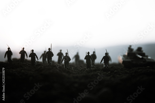 War Concept. Military silhouettes fighting scene on war fog sky background, World War Soldiers Silhouettes Below Cloudy Skyline at sunset. Attack scene. Armored vehicles. © zef art