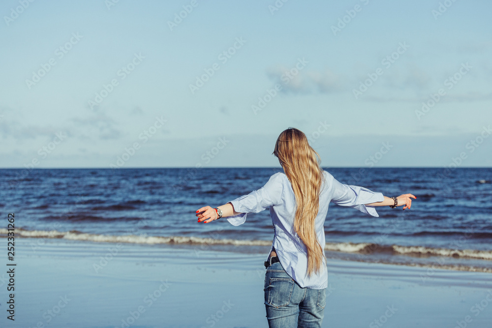 Active fitness sporty caucasian blondie young woman running on the coast of ocean smiling and laughing. Positive emotions, sport, sea, active life concept Active fitness sporty caucasian blondie young woman running on the coast of ocean smiling and laughing. Positive emotions, sport, sea, active life concept