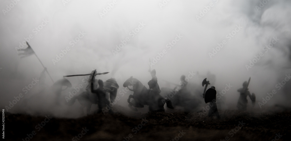 Medieval battle scene with cavalry and infantry. Silhouettes of figures as separate objects, fight between warriors on sunset foggy background. - obrazy, fototapety, plakaty 