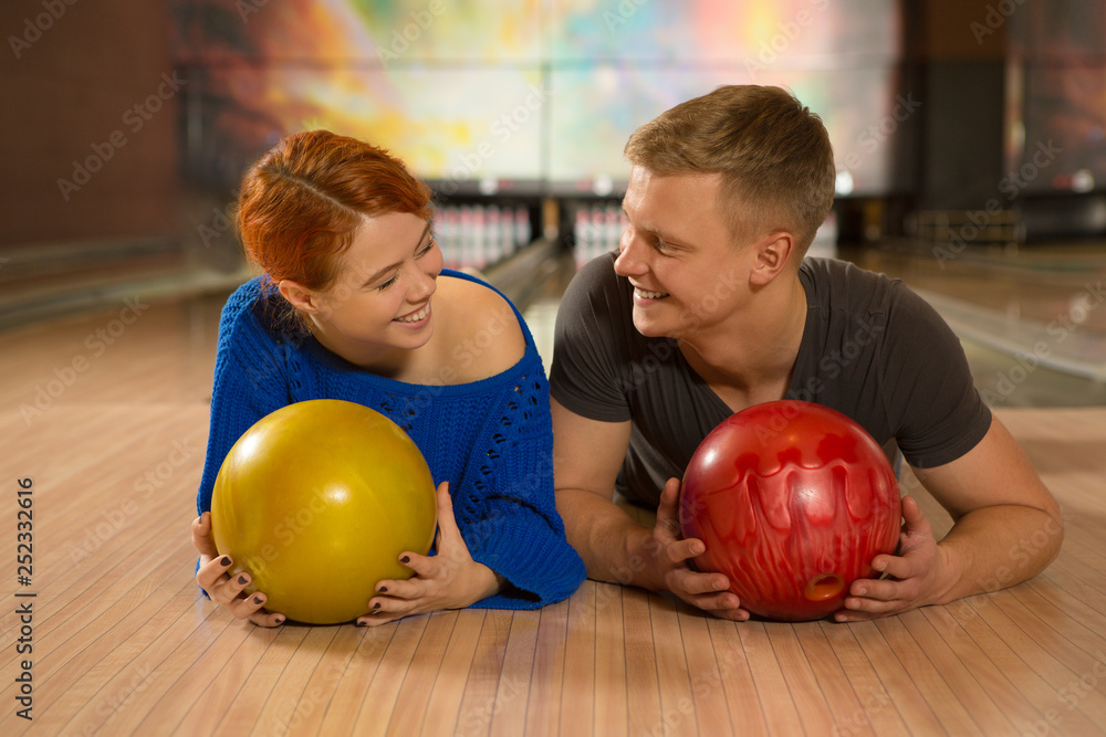 Fototapeta premium Beautiful happy couple bowling together at the local club