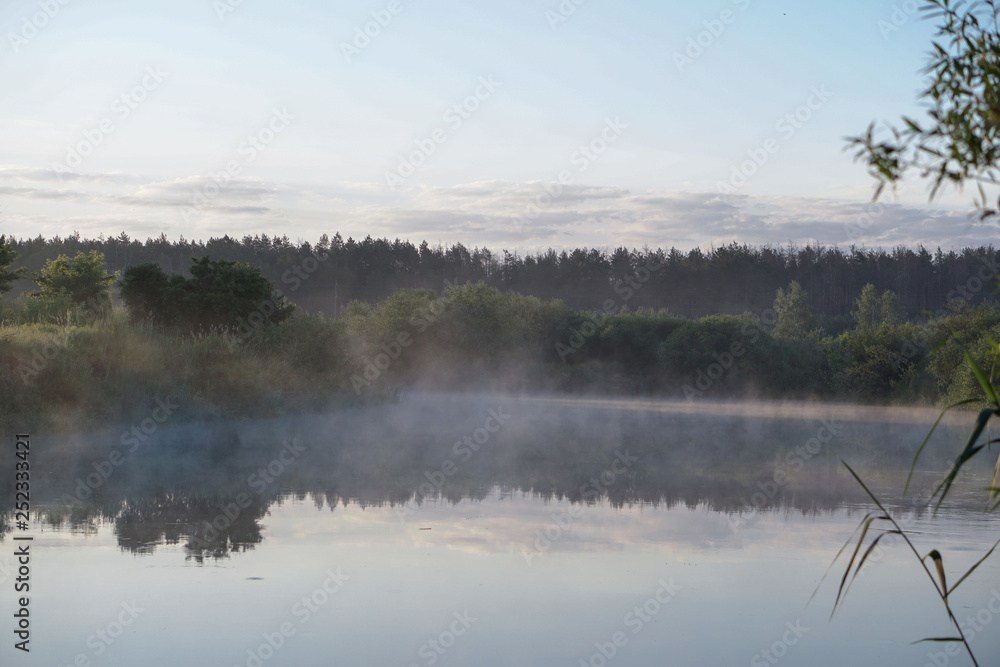 Pretty river in the countryside is shrouded in mist. European landscape of Russia and Siberia. calm view of nature. Stock background, photo Pretty river in the countryside is shrouded in mist. European landscape of Russia and Siberia. calm view of nature. Stock background, photo