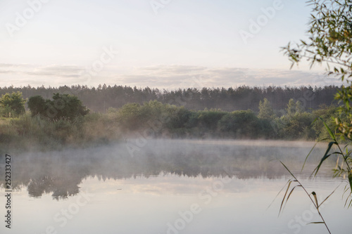 Pretty river in the countryside is shrouded in mist. European landscape of Russia and Siberia. calm view of nature. Stock background, photo