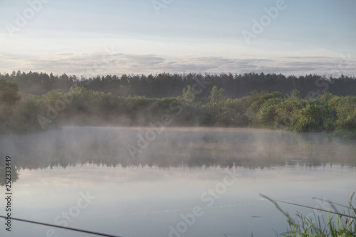 Pretty river in the countryside is shrouded in mist. European landscape of Russia and Siberia. calm view of nature. Stock background, photo