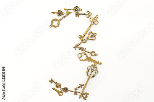 Decorative keys of different sizes, stylized antique on a white background. Form the centerpiece. Number three