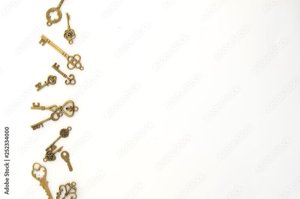 Decorative keys of different sizes, stylized antique on a white background. On the left border of the frame Decorative keys of different sizes, stylized antique on a white background. On the left border of the frame
