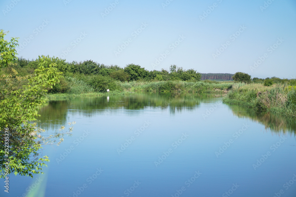 Pretty river in rural areas. European landscape of Russia and Siberia. Beautiful tranquil view of nature. Stock background, photo.