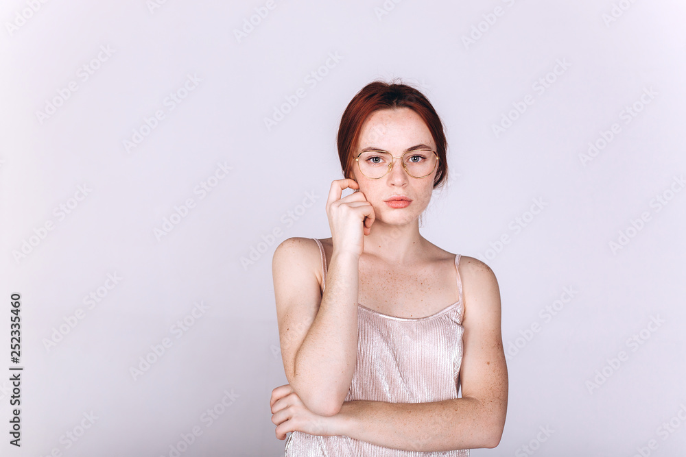 Young serious tender depressed woman on grey background Young serious tender depressed woman on grey background