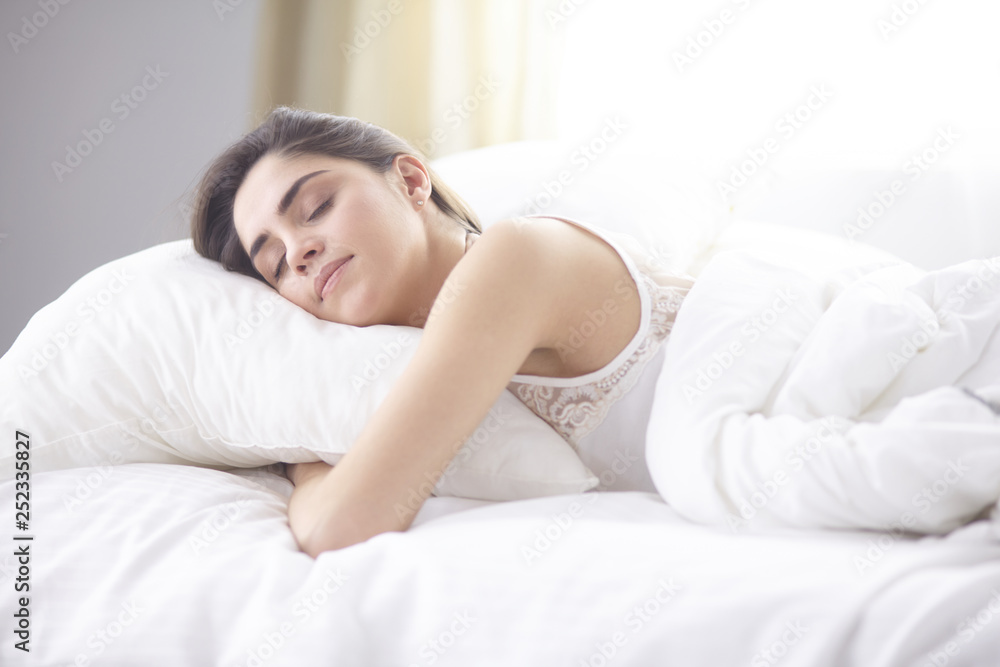 beautiful young woman basking in bed in the morning. Beautiful Model face looks sexy in camera beautiful young woman basking in bed in the morning. Beautiful Model face looks sexy in camera
