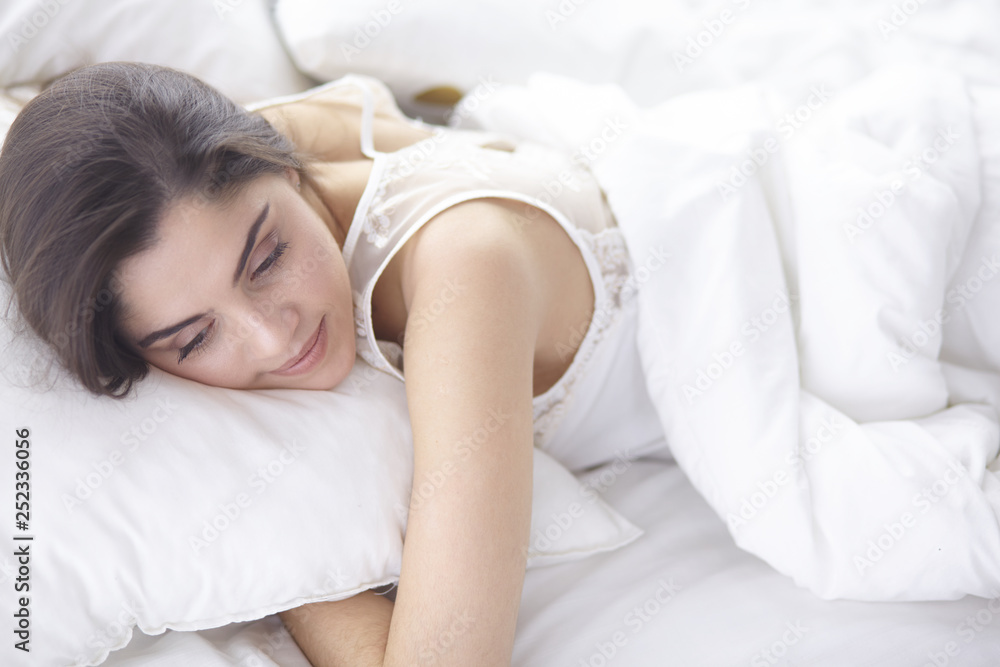 beautiful young woman basking in bed in the morning. Beautiful Model face looks sexy in camera beautiful young woman basking in bed in the morning. Beautiful Model face looks sexy in camera