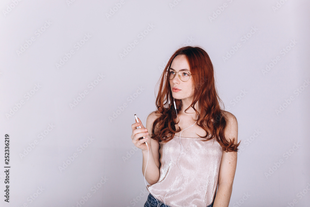 Young woman with smartphone do shopping, connecting with internet, listening to music, learning. Student girl on white background. Education, technology concept Young woman with smartphone do shopping, connecting with internet, listening to music, learning. Student girl on white background. Education, technology concept