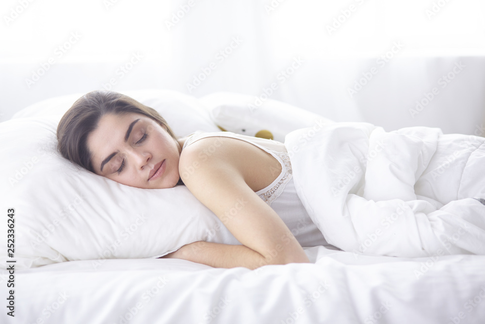 beautiful young woman basking in bed in the morning. Beautiful Model face looks sexy in camera beautiful young woman basking in bed in the morning. Beautiful Model face looks sexy in camera