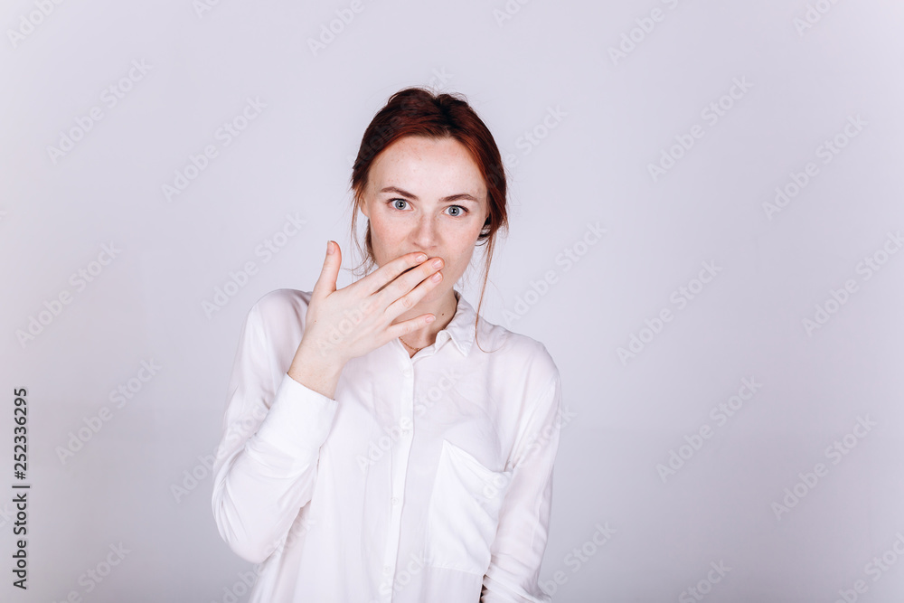 Young positive ginger girl with freckles isolated posing in studio on grey background. Natural beauty, casual, yoga, harmony, healthy lifestyle concept Young positive ginger girl with freckles isolated posing in studio on grey background. Natural beauty, casual, yoga, harmony, healthy lifestyle concept
