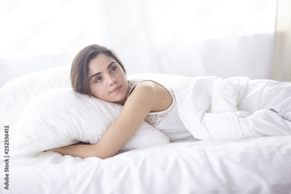beautiful young woman basking in bed in the morning. Beautiful Model face looks sexy in camera beautiful young woman basking in bed in the morning. Beautiful Model face looks sexy in camera